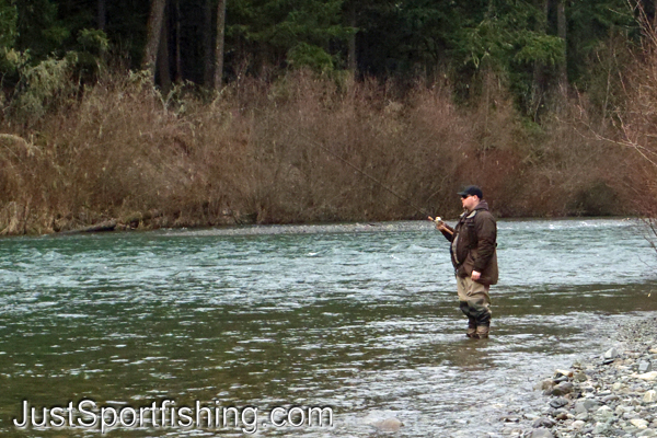 Photo of a steelhead fisherman standing in a river.