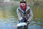 fisherman with steelhead trout photo