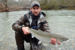 fisherman with steelhead trout photo